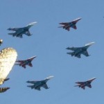 Russian fighters fly in formation over the two-headed eagle during a military parade in Red Square in Moscow, May 9, 2010