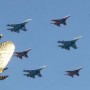 Russian fighters fly in formation over the two-headed eagle during a military parade in Red Square in Moscow, May 9, 2010