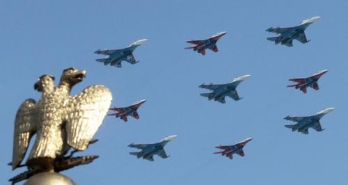 Russian fighters fly in formation over the two-headed eagle during a military parade in Red Square in Moscow, May 9, 2010