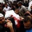 Palestinians carry one of five dead bodies of Islamic Jihad militants into the morgue of Al Najar hospital following an Israeli air strike on an Islamic Jihad training base in Rafah, southern Gaza Strip, Saturday, Oct. 29, 2011. Israeli aircraft killed 5 Palestinian militants from the Islamic Jihad group whom it says were responsible for recent rocket attacks on Israel, the military said Saturday. The military said it targeted the same group of militants that fired rockets that exploded near the Israeli city of Ashdod Wednesday night. No Israelis were injured in that attack. (AP Photo/Eyad Baba)