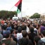 In this photo released by China's Xinhua News Agency, people attend a protest in the eastern Libyan town of Derna, Feb. 23, 2011.