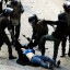 Brutal: This shocking image shows Egyptian army soldiers dragging this helpless woman on the ground and kicking her hard in the chest after ripping her clothes from her body