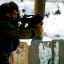 Aug. 26, 2011: An Israeli soldier fires tear gas canisters at Palestinian protesters during a protest march at the Qalandia checkpoint between the West Bank city of Ramallah and Jerusalem.