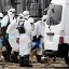 Japan's Fukushima police officers carry a victim to a vehicle in Minami Soma