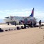 Tim Cole/AP - In this photo provided by passenger Tim Cole, a Delta Air Lines jet en route to San Diego from Detroit sits at a remote area of Albuquerque International Sunport, Sunday, after a bomb scare.