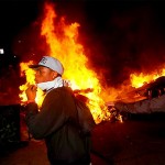 Riots: Occupy Oakland protesters pass a burning rubbish heap during a confrontation with police