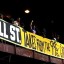 Members of a coalition called "Stand up Chicago" hang a banner from a bridge outside the Mortgage Bankers Association convention in Chicago October 10, 2011. The Wrigley Building is in the background. REUTERS/Frank Polich