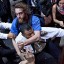 Fight: A man affiliated with the Occupy Wall Street protests tackles a police officer during a march towards Wall Street on Friday after the demonstrators were told they can stay at Zuccotti Park