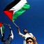 Palestinians wave their national flag in front of the headquarters of UNESCO in November 2011. The Palestinian flag will be hoisted Tuesday at UNESCO headquarters, over a month after its admission to the UN cultural agency sparked anger and reprisals from the United States and Israel.