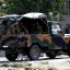 MURAD SEZER/REUTERS - Turkish soldiers in a military vehicle patrol near the Akcakale border gate, southern Sanliurfa province, October 4, 2012. Turkish artillery hit targets near Syria's Tel Abyad border town for a second day on Thursday.