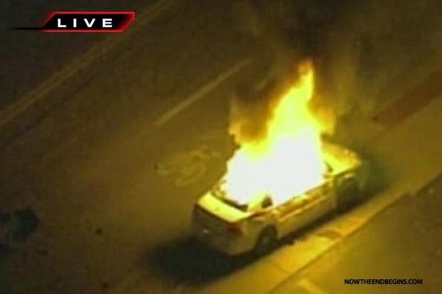 ferguson-protesters-set-police-car-on-fire