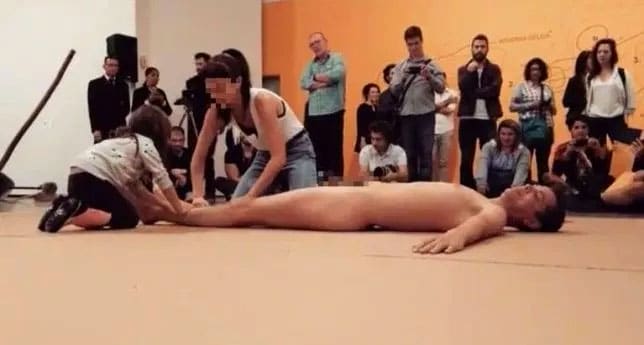 Footage showing a four-year-old child being encouraged to touch a naked man’s body for a performance art stunt has sparked outrage in Brazil. 