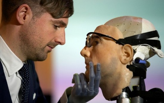 Researcher Bertolt Meyer, a lifelong user of prosthetic technology and the model for 'Rex', the world's first 'bionic man', poses with the humanoid during a photo call at the Science Museum in London on February 5, 2013. The 640,000 GBP (1 million US dollars) bionic has a distinctly human shape and boasts prosthetic limbs, a functional artificial blood circulatory system complete with artificial blood, as well as an artificial pancreas, kidney, spleen and trachea. Rex will be displayed at the Science Museum from February 7.